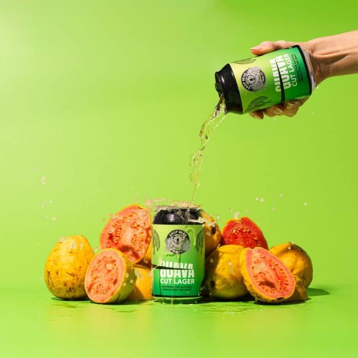 Guava Lager being poured over can of guava lager.